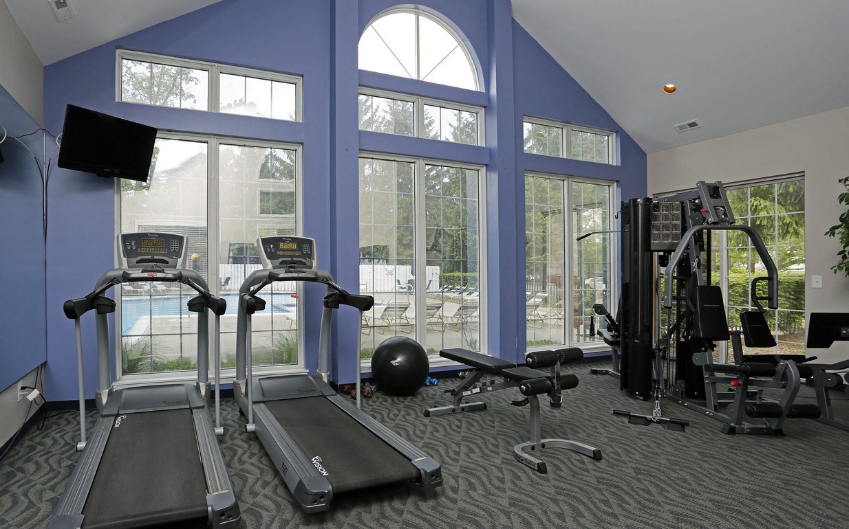 the gym at the monarch apartments in des plaines has cardio equipment and glass windows